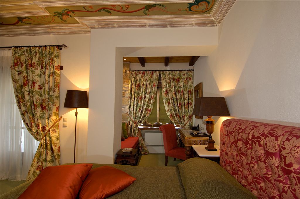 Luxury double room with stone fireplace and timber ceiling