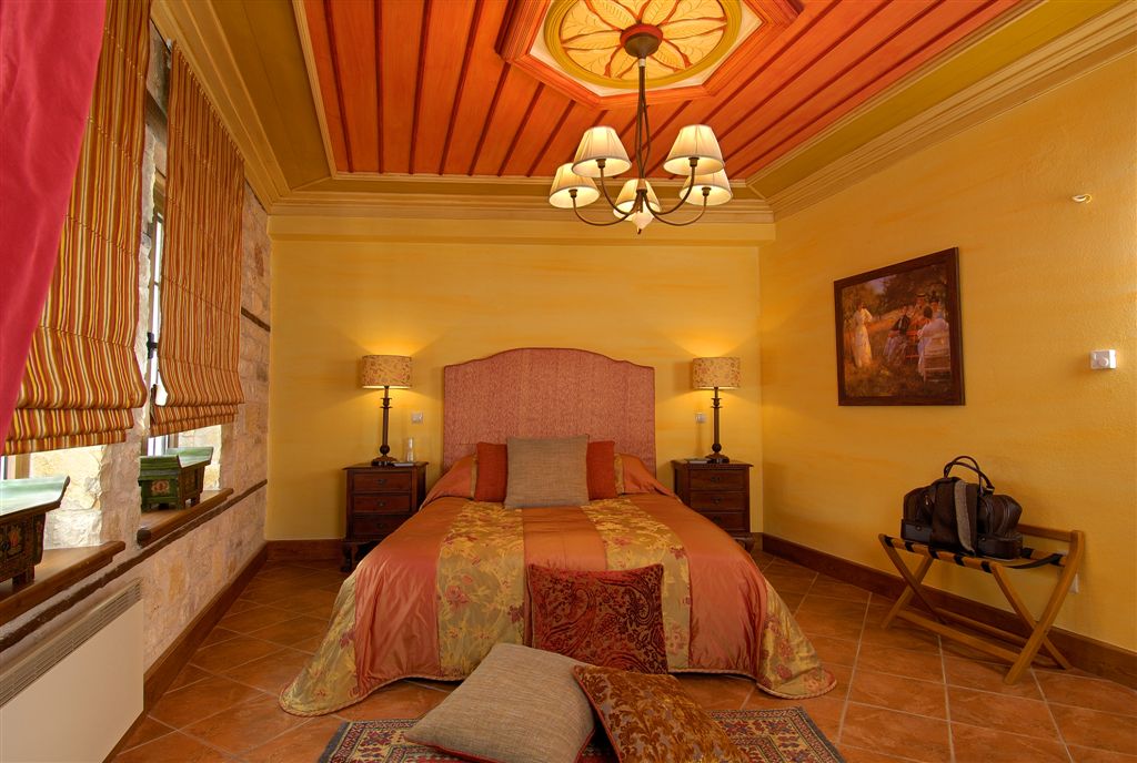 Suite interior with painted wooden ceiling and mountain views
